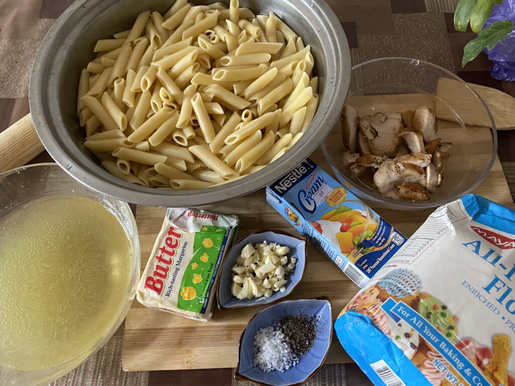 Creamy Chicken Penne Recipe: Ingredients include cooked penne pasta, broth, butter, garlic, salt, pepper, all-purpose flour, and cooked chicken pieces, ready for a delicious creamy pasta dish.