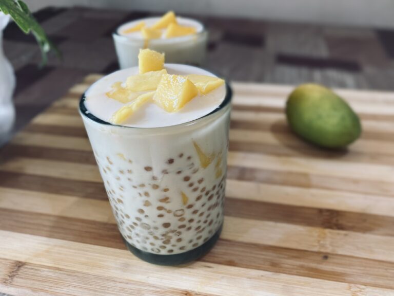 Mango tapioca drink in two glasses put on a wood.