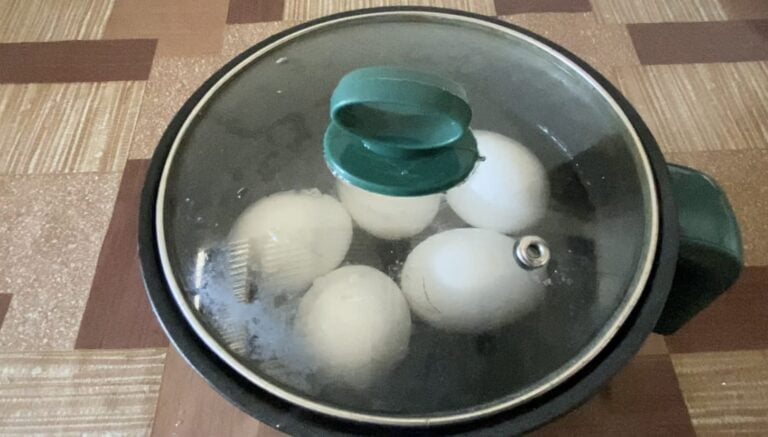 Eggs in a pot being boiled.